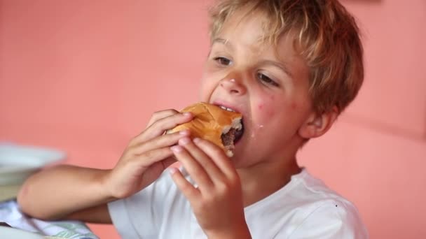Handsome Young Boy Eating Hamburger Child Takes Bite Burger — Stock Video