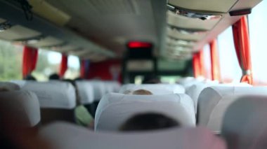 Back of bus traveling on road trip. Passenger perspective POV
