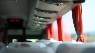 Interior shuttle perspective traveling on road, back of bus POV