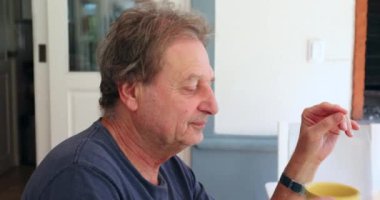 Older man drinking morning cup of coffee