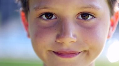 Smiling child looking to camera. Handsome young boy portrait close-up face