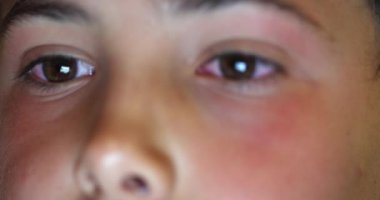 Boy eyes staring at screen at night. Child macro close-up eye watching content online