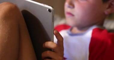 Bilgisayar oyunu oynayan çocuk elinde teknoloji tableti aygıtı tutuyor