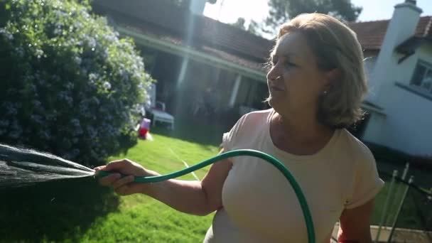 Woman 60S Watering Garden Water Hose — Vídeo de Stock