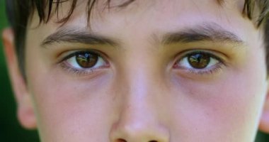 Serious child boy face eyes macro closeup looking to camera