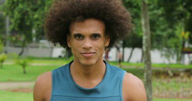 African black man portrait walking forward towards camera at park