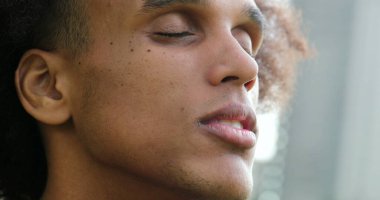 African american black man face opening eyes smiling feeling happy and contemplation