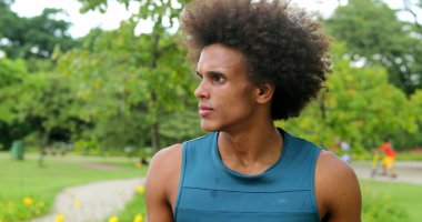 african man thinking contemplative at park