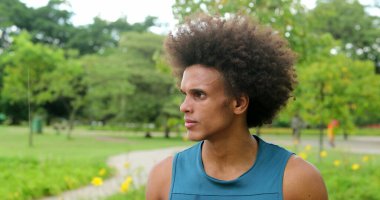 african man thinking contemplative at park