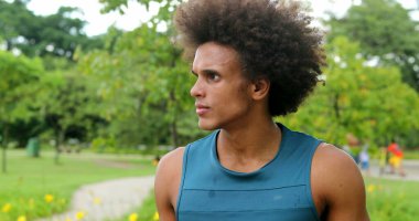 african man thinking contemplative at park