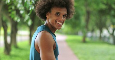 Back of handsome african black man turning around and smiling
