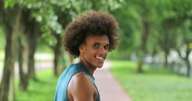 Back of handsome african black man turning around and smiling