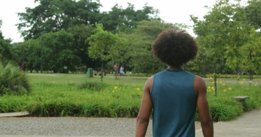 Back of african american person walking in nature outdoors, contemplating thinking about life
