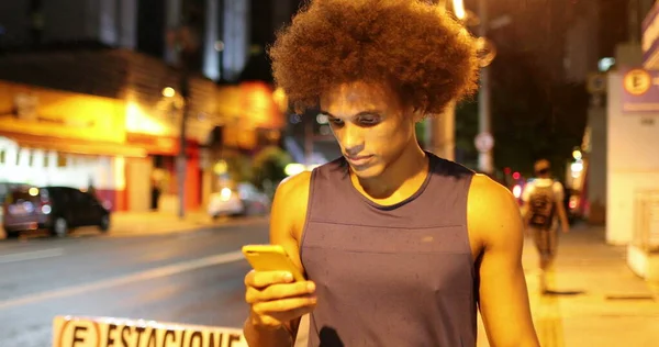 Black African Man Walking Night Downtown City Holding Smartphone Device — Stock Fotó