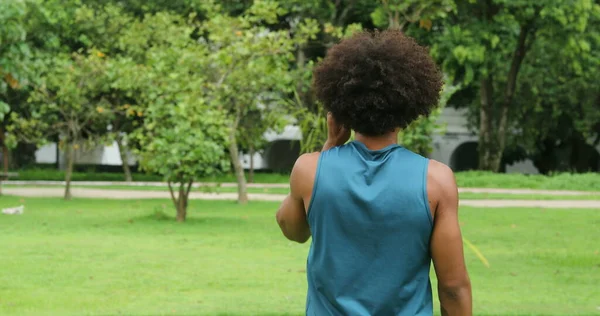 Back of african black man walking at park outdoors