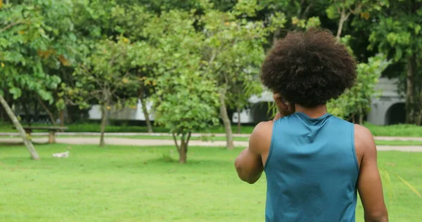 Casual candid young african american male walking at park outdoors