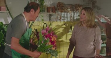 Businesswoman owner of flower shop delegating orders to employees. Staff of floriculture store organizing online orders for delivery