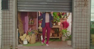 Female small business owner opening shop. Woman opening flower shop gate. Entrepreneur floriculture local store owner. Businesswoman opens shutter door at sidewalk