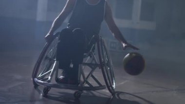 South American disabled athlete playing ball in a wheelchair. Basketball hispanic player