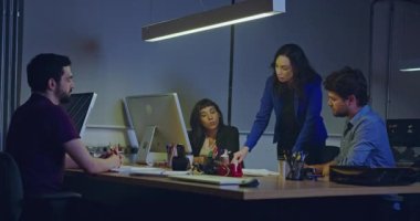 Yönetici bayan iş kadını personelin önünde konuşuyor. Toplantıdaki çalışanlar bayan bir patronu dinliyorlar.