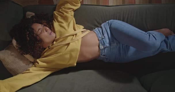 Young Woman Stretching Body Resting Sofa Angle Black Girl Relaxing — Stockvideo
