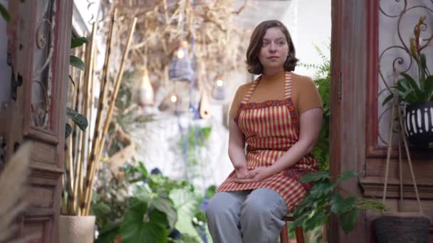 Thoughtful Woman Woman Sitting Stool Floriculture Store Pensive Female Employee — Wideo stockowe