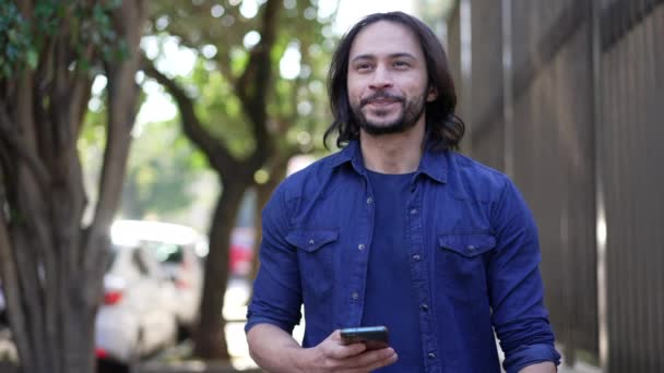 Casual Joyful South American Man Checking Smartphone Walking City Street — Stock videók