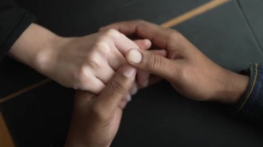 Young couple hands joining in care and support. Closeup hand togehter in union. reaching out for friend