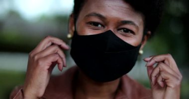 Kadın kovid yüz maskesi çıkarıyor. Rahatlama hissi, salgının sonu.