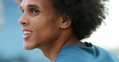 Handsome young mixed race black african man smiling and feeling happy