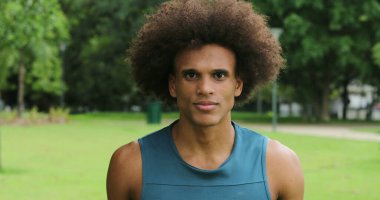 Mixed ethnicity african man walking at park outdoors