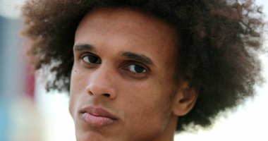 Serious handsome african mixed race man facing camera portrait