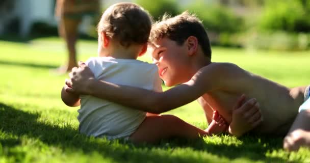 Siblings Together Grass Baby Infant Older Brother Outdoors — Stock Video