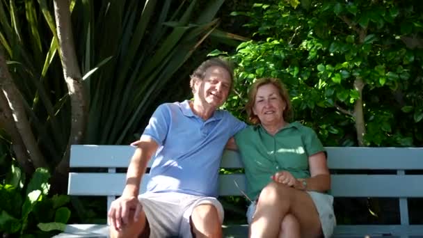 Happy Senior Couple Sitting Park Bench — Stockvideo