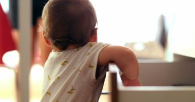 Baby grabbing something from drawer