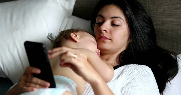 Mother Using Cellphone Device Home Lying Bed Sleeping Baby Chest — Foto Stock
