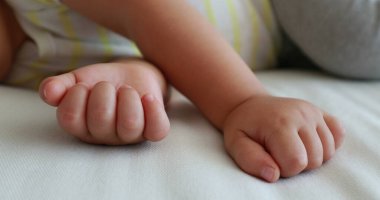 Baby hands sleeping, close-up of toddler infant hand and fingers asleep