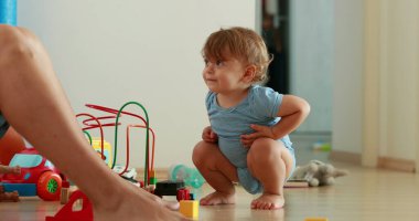 Baby paying attention, one year old infant toddler at home