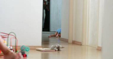 Candid baby walking and falling at home. Real life fall. One year old infant learning to walk