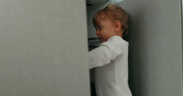 Baby Standing Kitchen Floor Opening Closet Door Cupboard Cabinet — стоковое фото