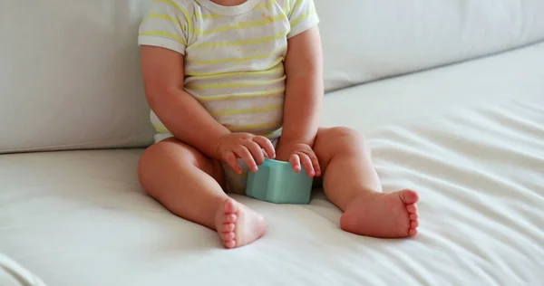 Calm baby boy on home couch. Sweet cute infant one year old child on sofa