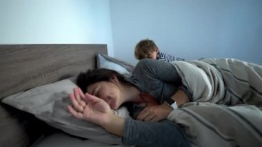 Mother lying in bed in the morning