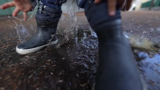 Little Child Jumping Puddle Wearing Boots — Vídeo de Stock