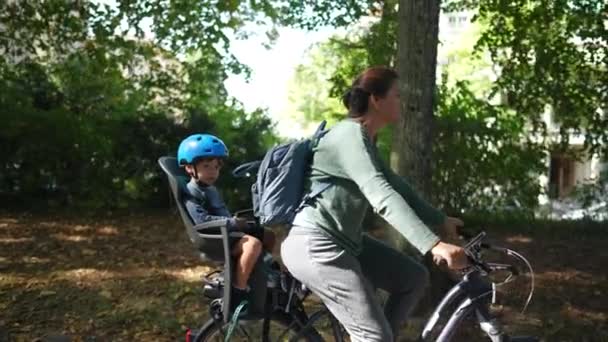 Mother Riding Bicycle Child Bike Back Seat — Stock Video