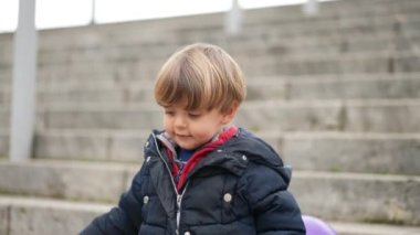 Küçük çocuk merdivenlerden iniyor. Çocuk aşağı yürür