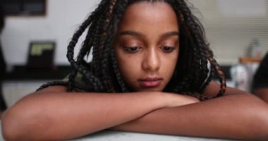 Düşünceli küçük kız düşünüyor. Karışık ırk çocuğu, yüz yüze.