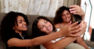 Evde cep telefonuyla selfie çeken iki küçük kız, akıllı telefon kullanan çocuklar.