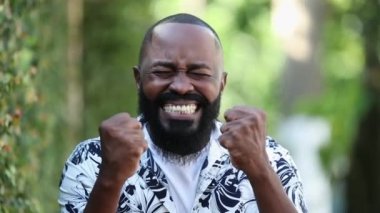 Heyecanlı kendinden emin Afrikalı adam başarıyı alkışlıyor