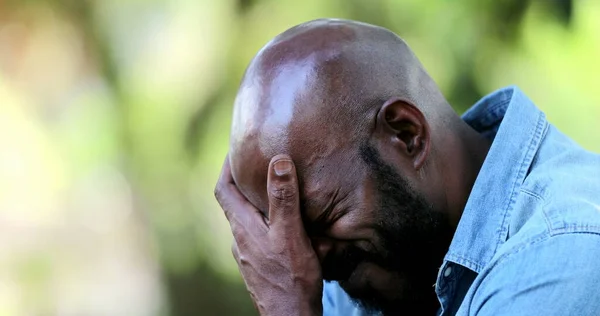 African man sad receiving negative news