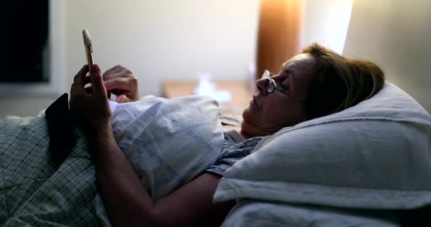 Yaşlı Kadın Gece Yatakta Akıllı Telefon Kullanıyor Cep Telefonu Ekranına — Stok video